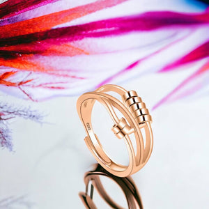 Anxiety fidget ring gold on pink abstract background