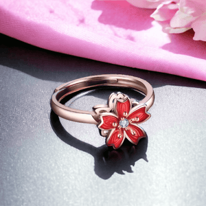Cherry blossom ring with spinning top rose gold on black shiny surface
