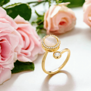 Gold anxiety fidget ring Australia next to pink roses