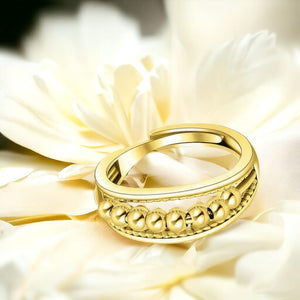 Gold fidget ring on a white flower