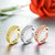 Silver, gold and rose gold worry rings on white background