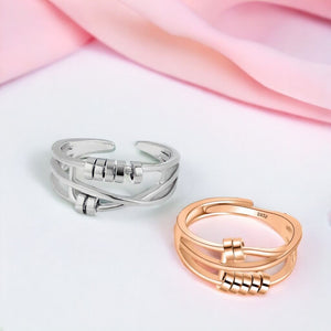 Two anxiety rings Australia sterling silver on white and pink background