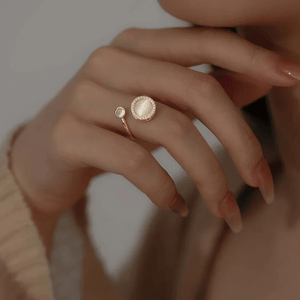 Woman wearing spinning ring jewellery gold on her ring finger