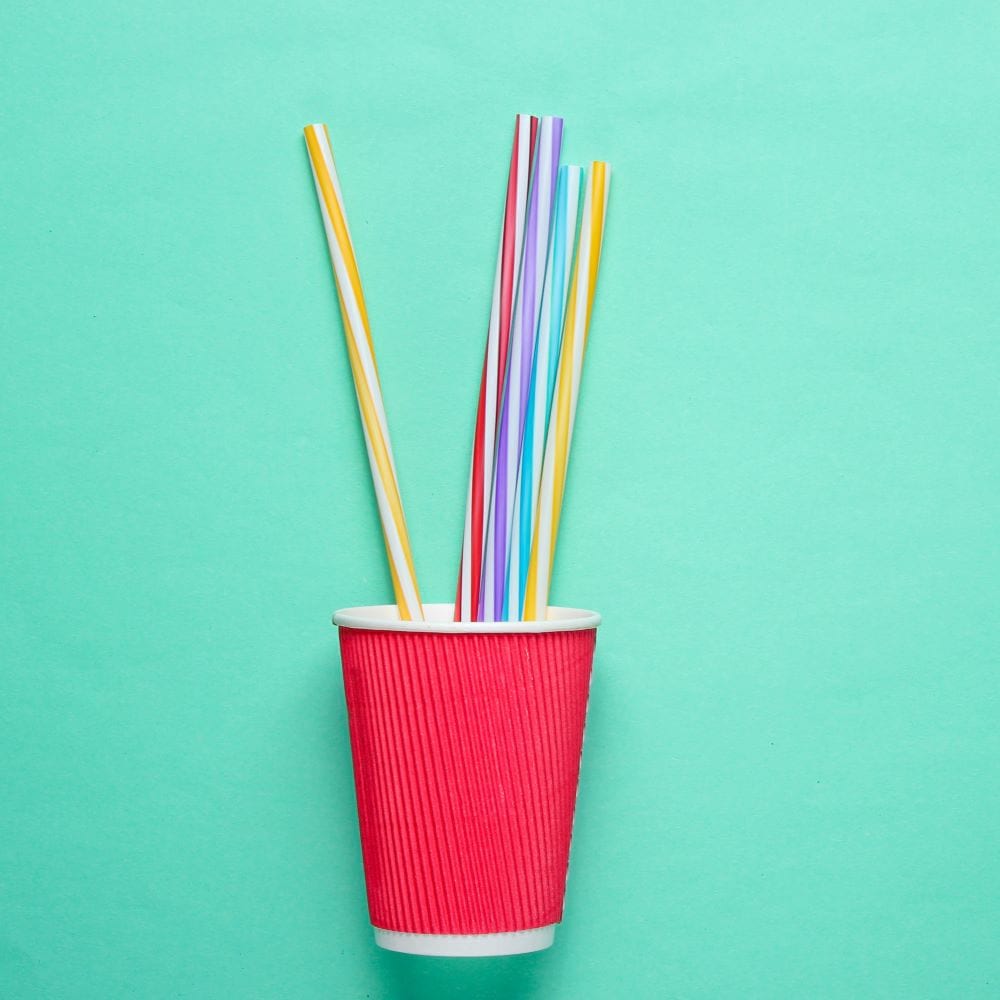 Red cardboard cup with plastic straws