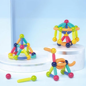 2D and 3D constructions made of magnetic toys balls and sticks on blue background