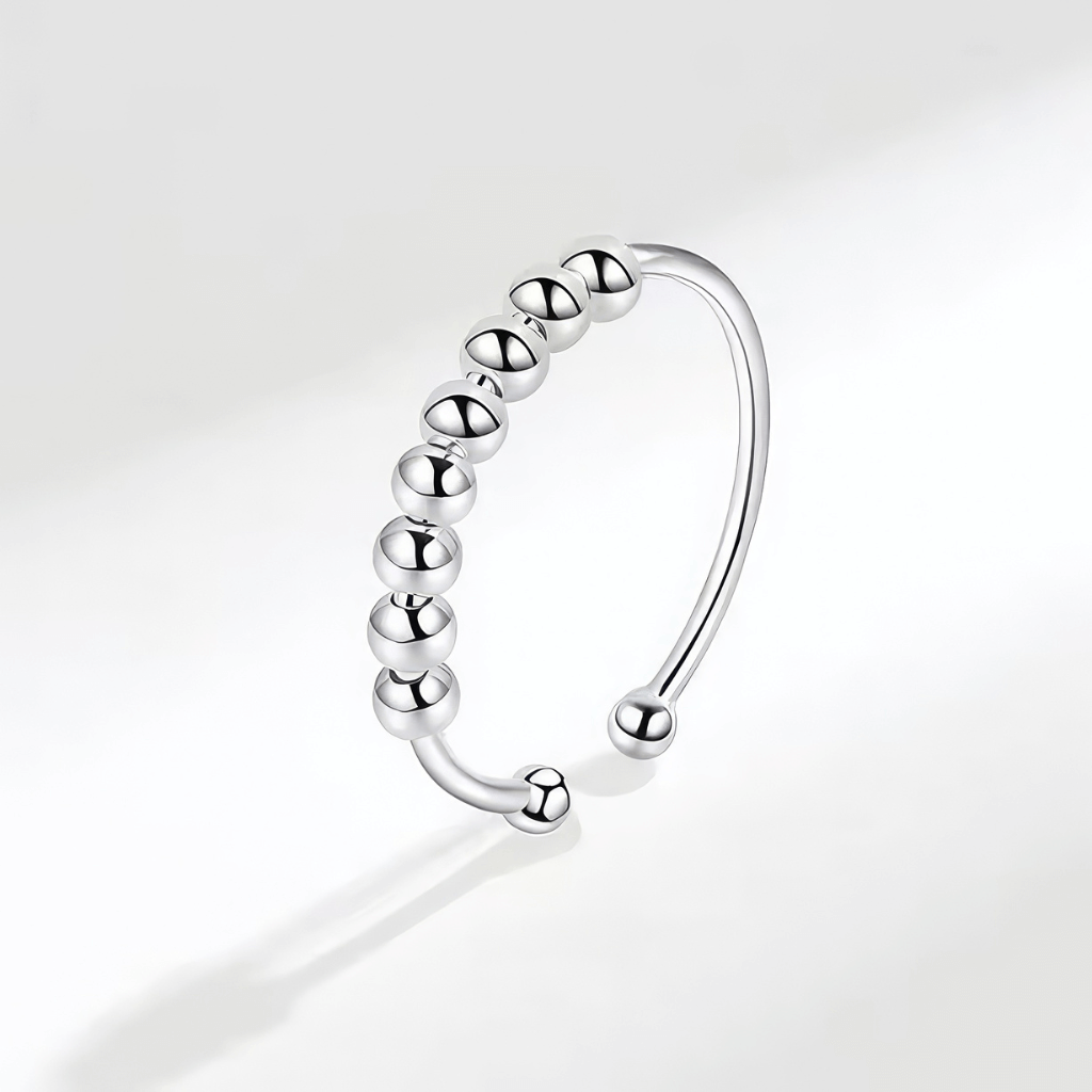 Adjustable ring sterling silver with eight beads on grey background