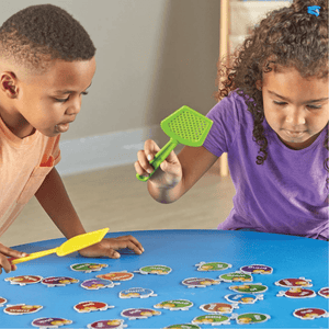 Afro-american boy and girl playing Sight Words Swat board game by Learning Resources at a blue table