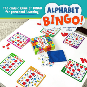 Alphabet Bingo board game by Peaceable Kingdom box and contents on a white coffee table