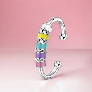 Anxiety ring with enamel beads adjustable on pink background