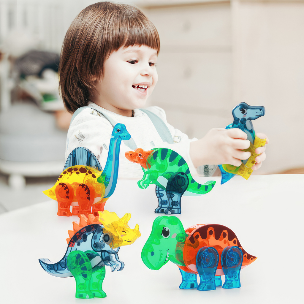 Asian girl playing with magnetic tiles dinosaurs