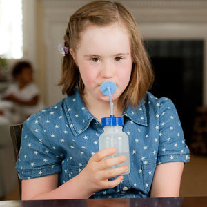 Autistic girl drinking with a Ark lip blok medium blue
