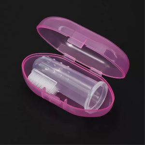 Baby finger toothbrush with gum massager in a pink case on black background