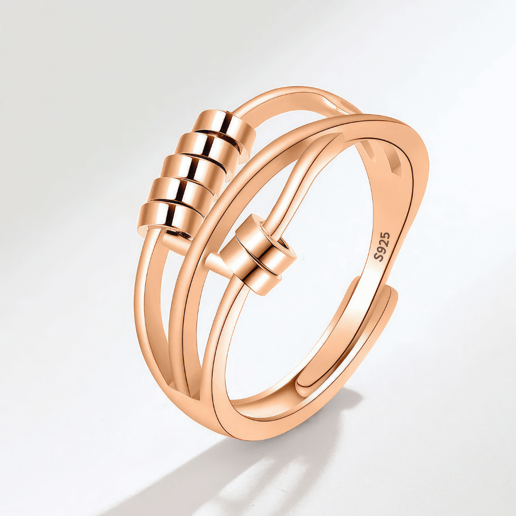 Beaded gold fidgeting ring on grey background