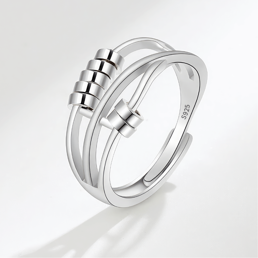 Beaded sterling silver worry ring on grey background