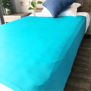 Bed with a fitted blue sensory compression sheet