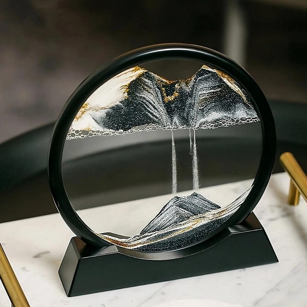 Black moving sand art in Australia on a marble tray and grey background