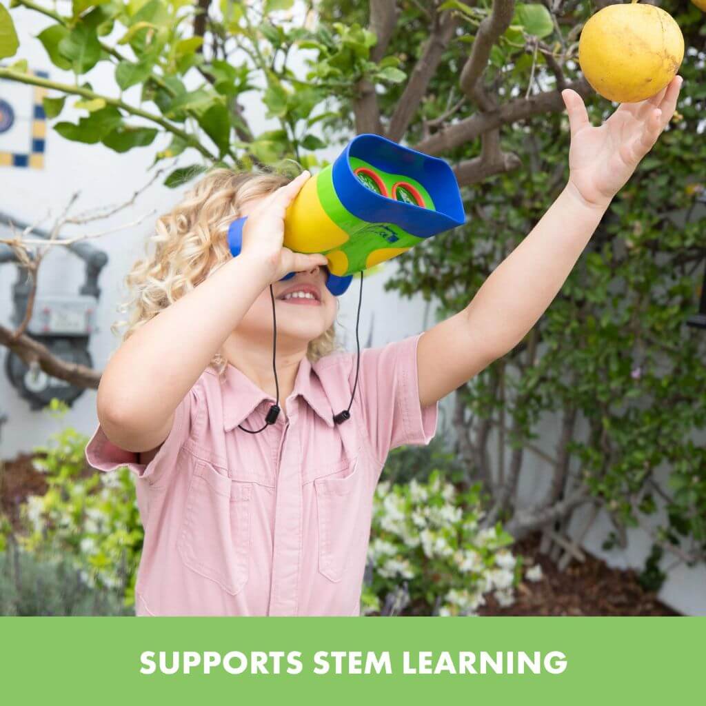Blonde girl with curly hair looking at an apple through GeoSafari Kidnoculars by Educational Insights