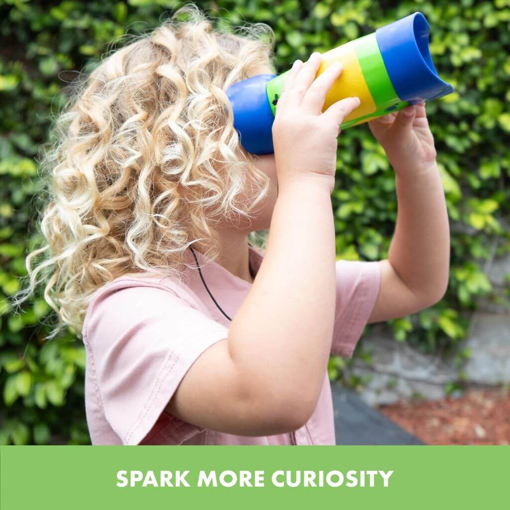 Blonde girl with curly hair looking through GeoSafari Kidnoculars by Educational Insights in a park
