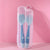 Blue-green bendable spoon and fork in a storage box on pink background