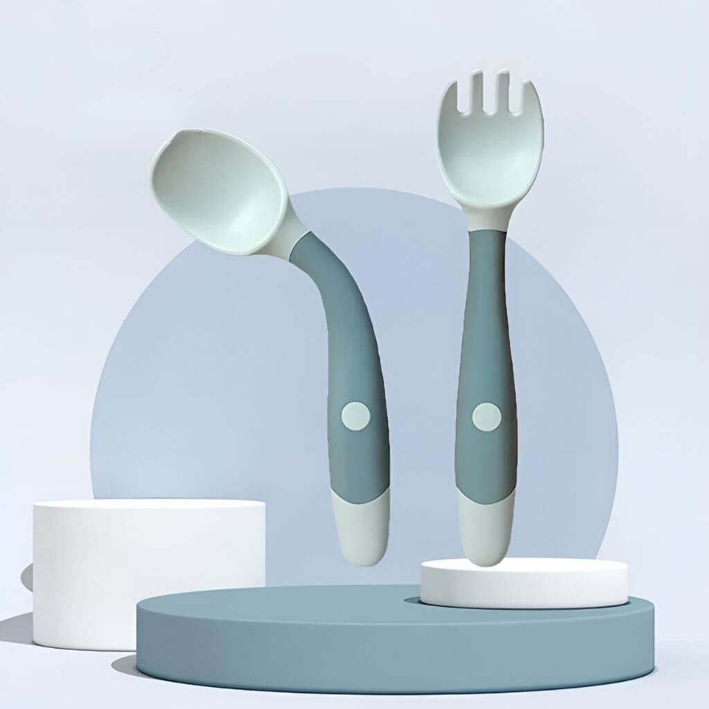 Blue-green bendable spoon and fork in a storage box on pink background