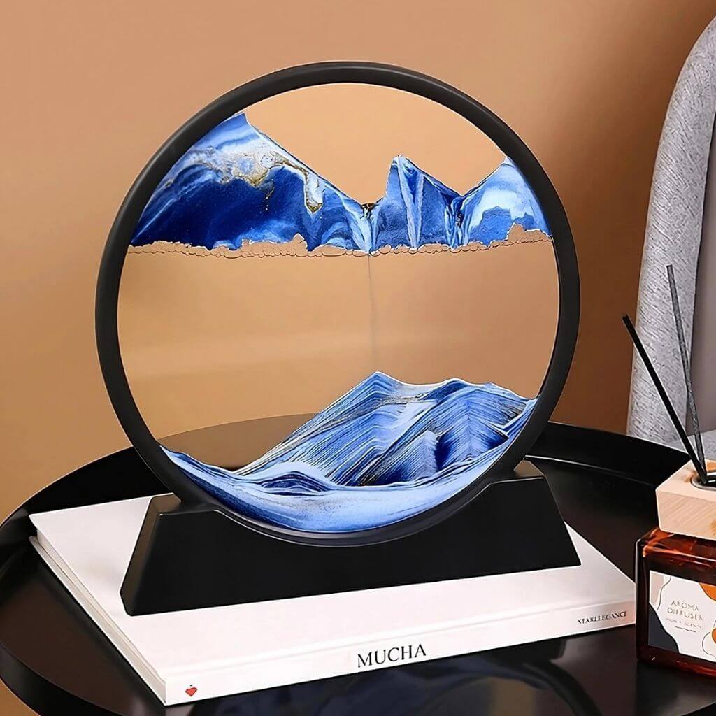 Blue moving sand art on a white book and brown background