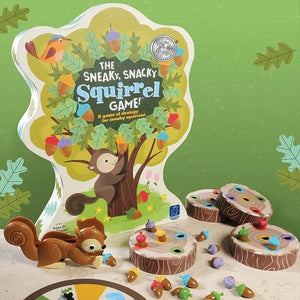 Box and contents of The Sneaky, Snacky Squirrel Game! by Educational Insights on green background