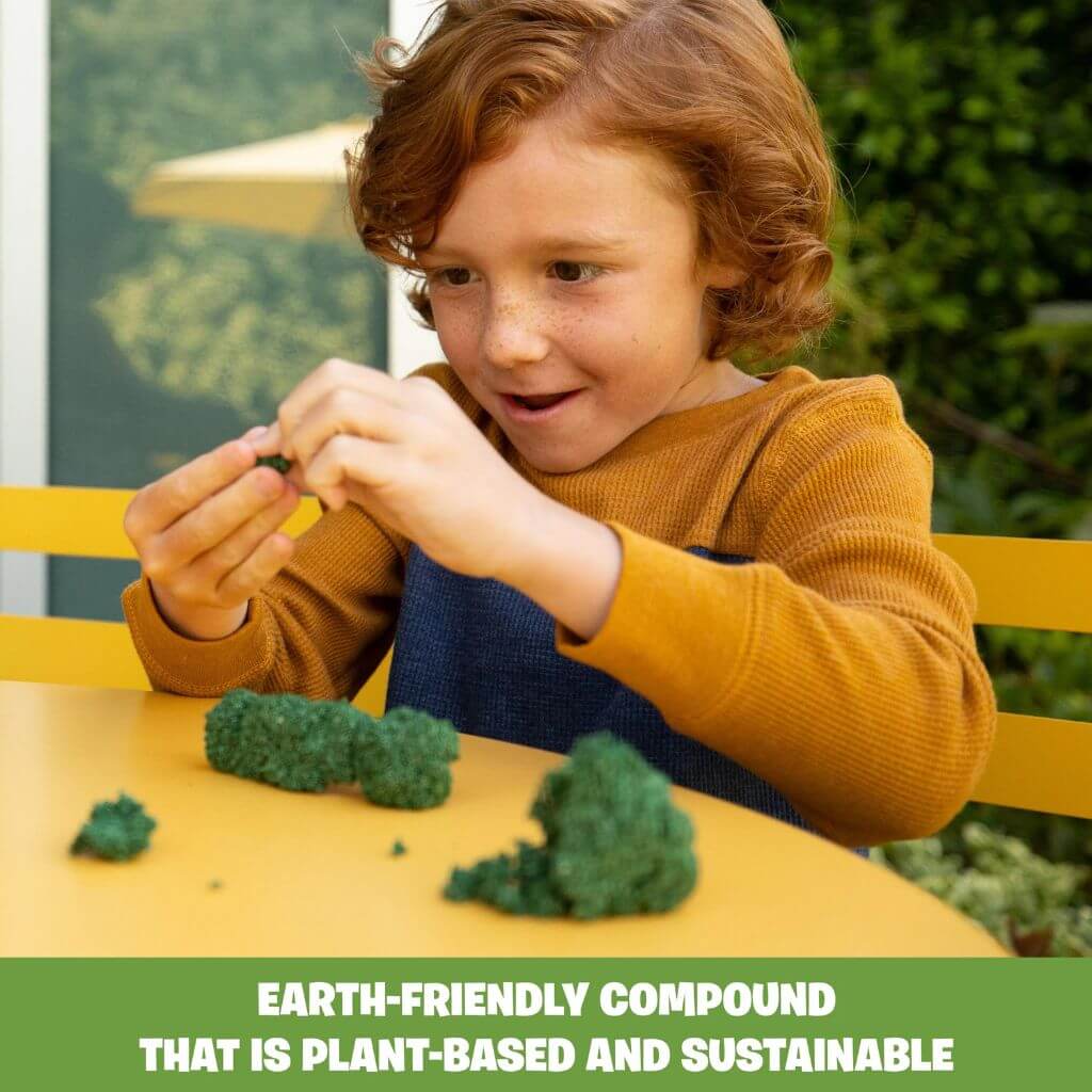 Boy with curly ginger hair playing with Playfoam Naturals Shape & Learn Letters & Numbers by Educational Insights at a yellow table