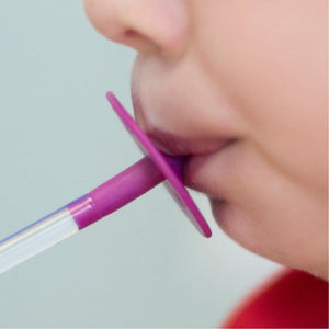 Boy drinking from Ark's Lip Blok Straw Mouthpiece Flexible magenta close up