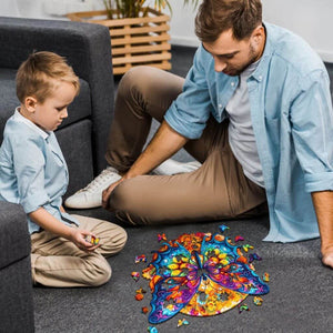 Boy and his father making a wooden butterfly puzzle on the floor