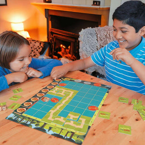 Boy and girl playing Race to the Treasure cooperative board game by Peaceable Kingdom