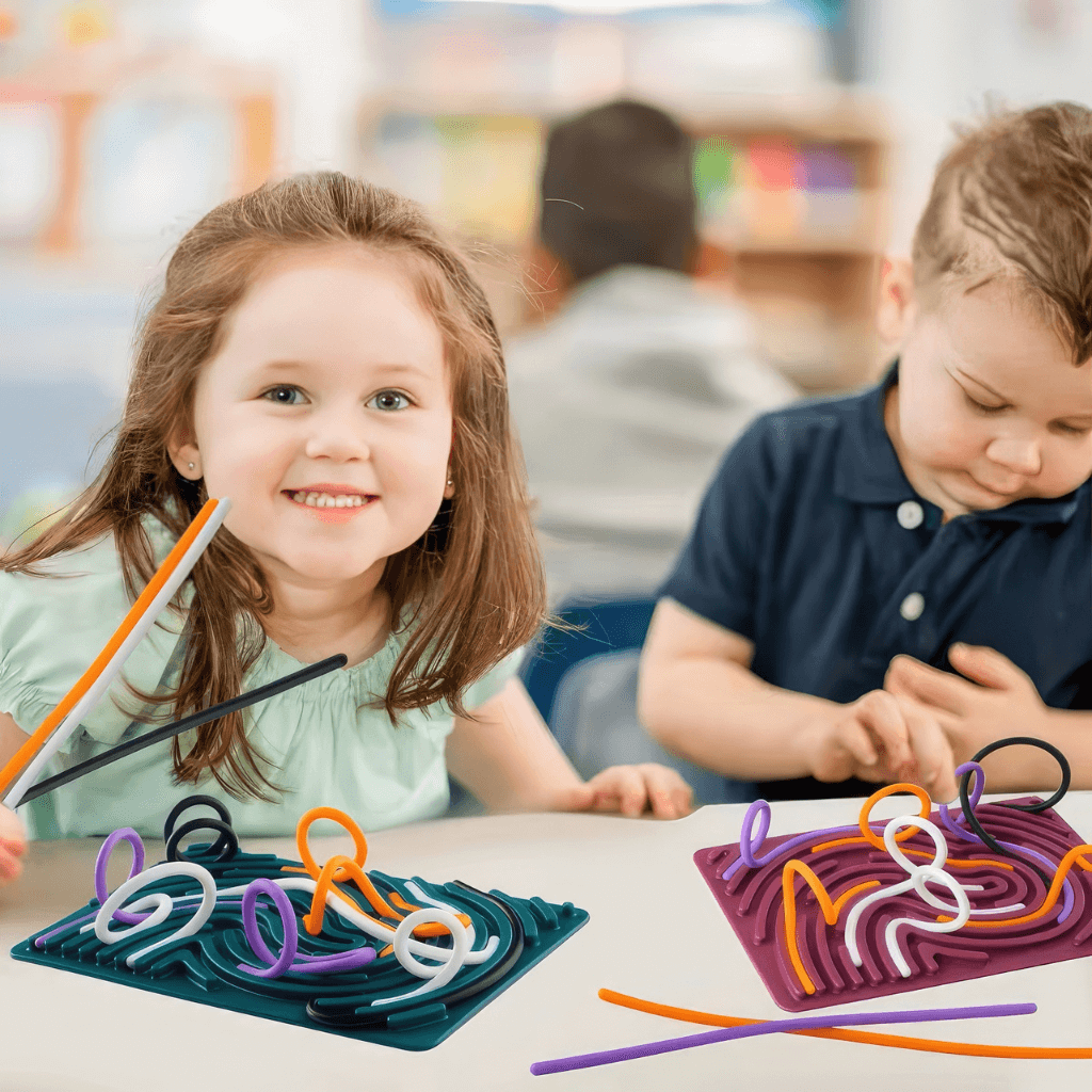 boy and girl playing with silicone activity boards