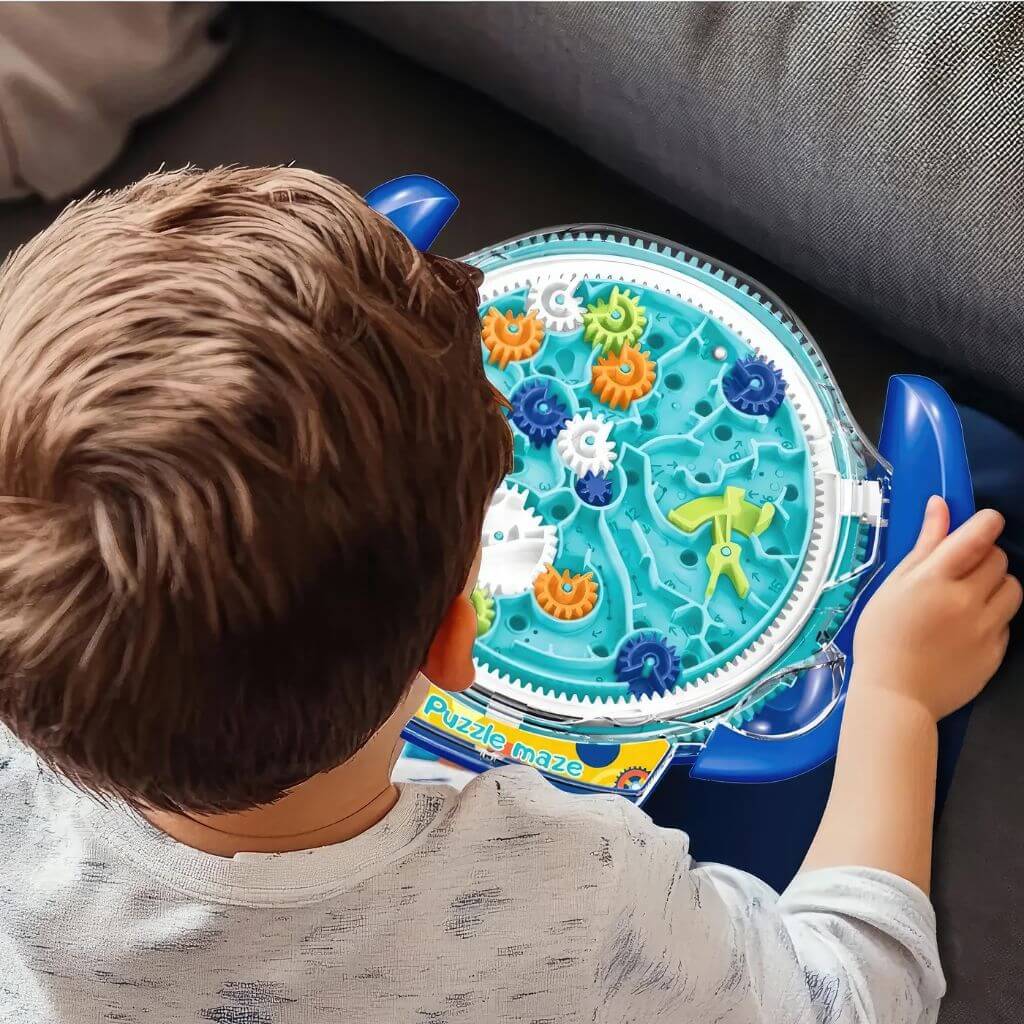 Boy playing with a gear maze puzzle
