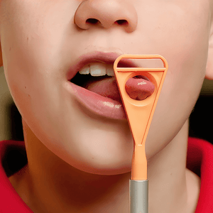 Boy's tongue sticking through Ark's tongue tip exerciser for Z-Vibe
