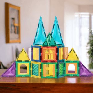 Castle made of magnetic tiles in Australia on a wooden surface with a window in background