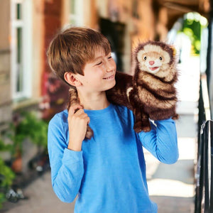 Caucasian boy carying a ferret puppet from Folkmanis on his shoulder