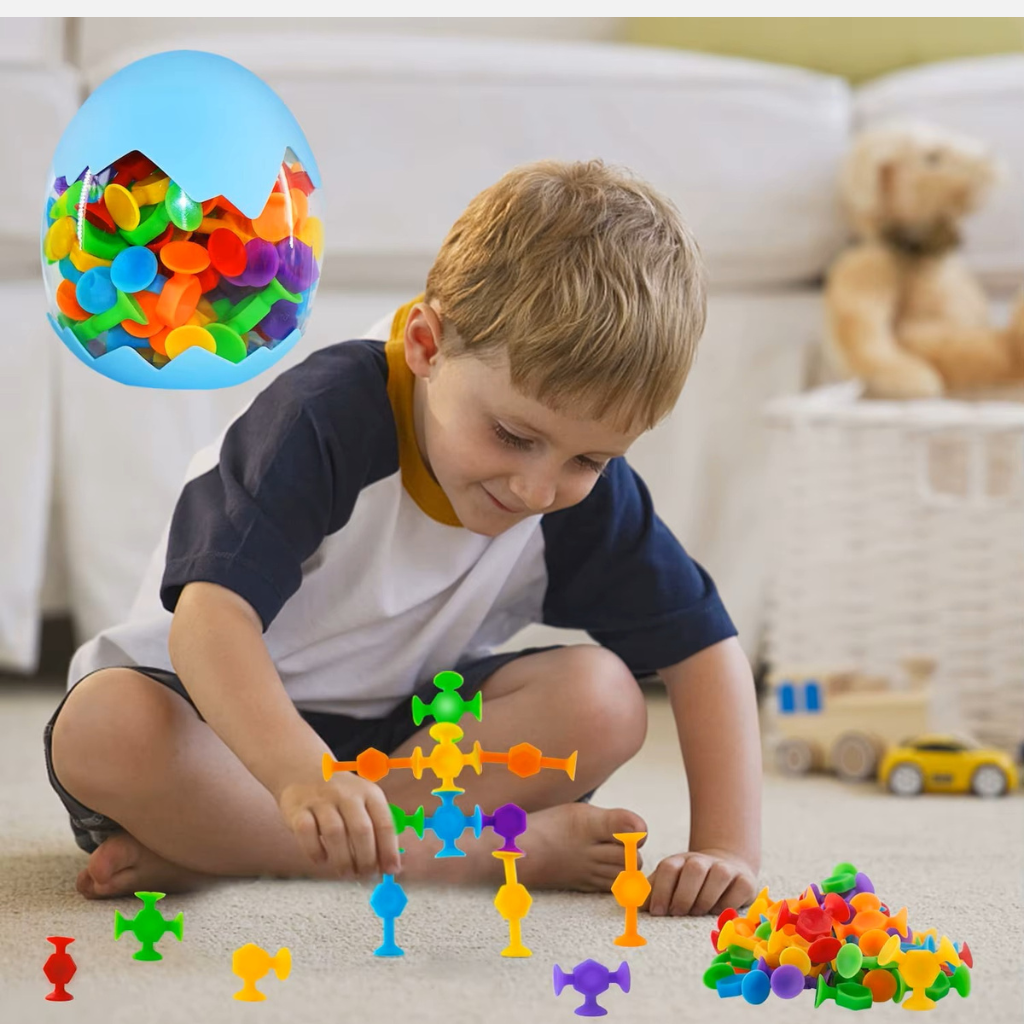 Caucasian boy playing with suction construction toys