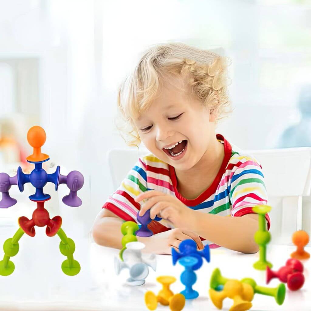 Caucasian boy playing with window suction toys