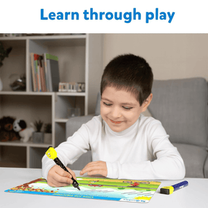 Caucasian boy playing with Skillmatics I Can Write Reusable Activity Mats