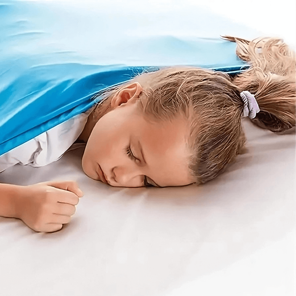 Caucasian girl in bed under a blue compression sheet