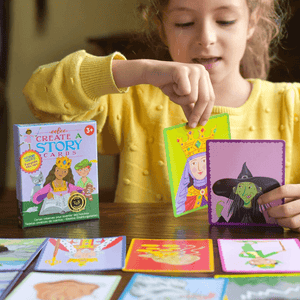 Caucasian girl playing with Fairytale Mix-ups Create a Story Cards by eeBoo