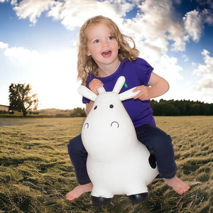 Caucasian girl riding Happy Hopperz White Cow animal bouncer