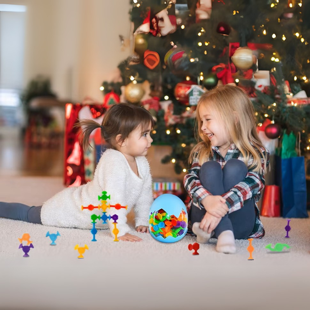 Caucasian girls playing with suction construction toys