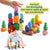 Caucasian toddler boy playing with stacking stones on white background