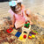 Caucasian toddler girl playing with a fine motor skills toy on the floor