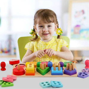 Caucasian toddler girl playing with a wooden stacking toy at a table