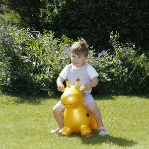 Caucazian toddler riding Happy Hopperz Gold Giraffe in the garden