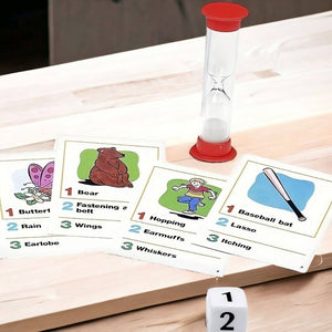 Charades for Kids cards, hourglass and dice on a wooden table