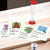 Charades for Kids cards, hourglass and dice on a wooden table