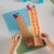 Child's hands building number twenty numberblocks mathlink cubes inspired by the TV on a white table
