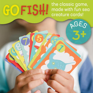 Child holding Card Game Go Fish by Peaceable Kingdom